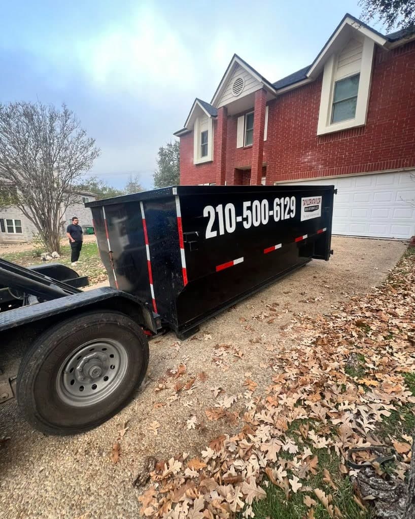 Taylor & Taylor dumpster on trailer at a brick residential job